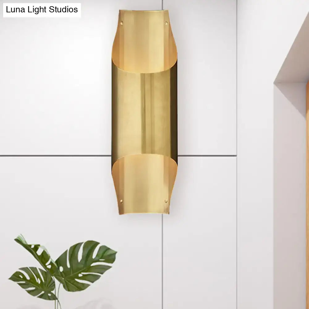 Contemporary curved brass wall lamp with sleek bulb base for modern living room with minimalist design