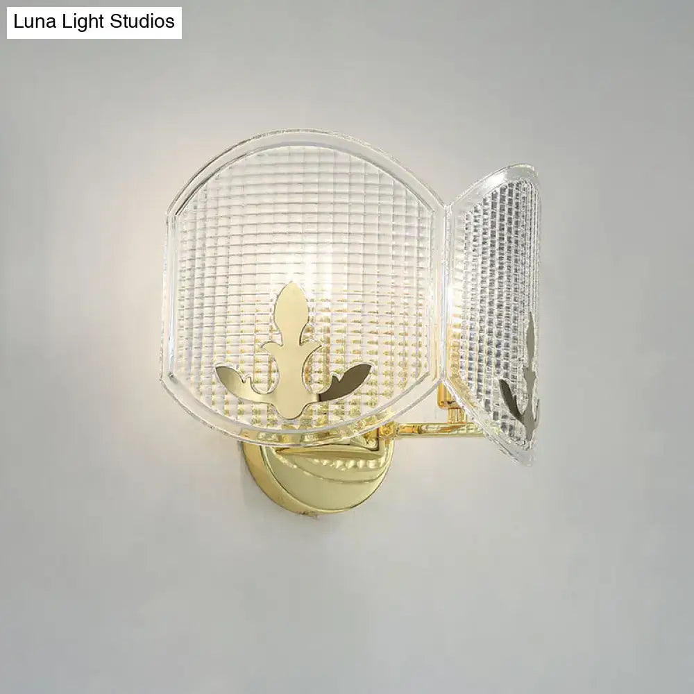 Contemporary gold arc light fixture wall sconce with gold finish and clear textured glass panels featuring leaf motif