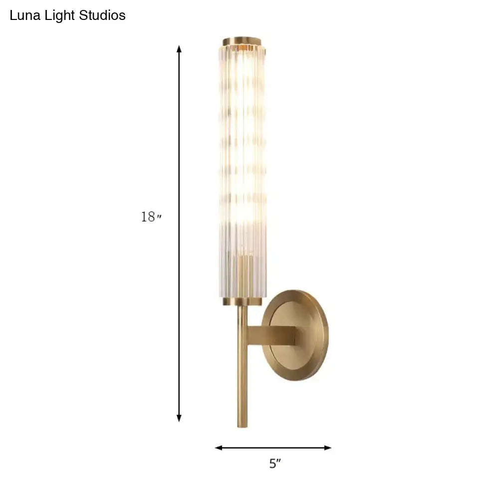 Contemporary gold brass cylinder wall light fixture with brushed brass finish and ridged glass shade for bedroom wall light