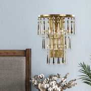 Contemporary gold crystal flute tiered wall sconce lighting with cascading clear crystal droplets for bedroom use
