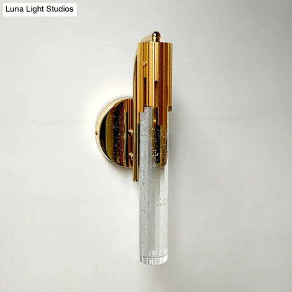 Contemporary gold-toned led light living room sconce with a bubble-textured glass cylinder and bulb included