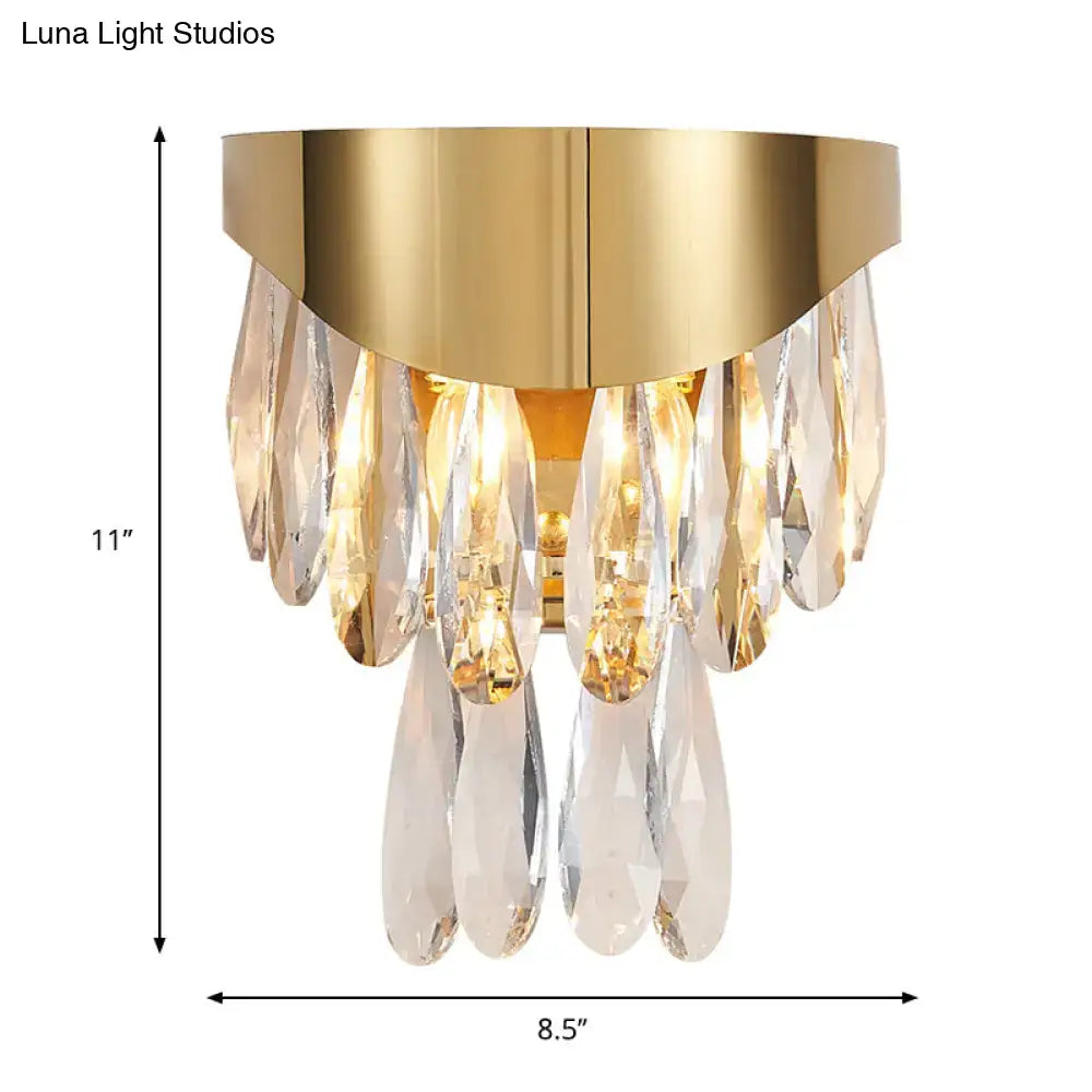 Contemporary gold crystal teardrop wall sconce featuring a gold finish and cascading clear crystal teardrops for bedroom lighting
