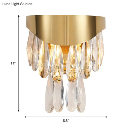 Contemporary gold crystal teardrop wall sconce featuring a gold finish and cascading clear crystal teardrops for bedroom lighting