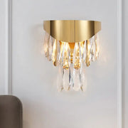 Contemporary gold crystal teardrop wall sconce featuring gold-toned metal and cascading clear crystal droplets for bedroom lighting