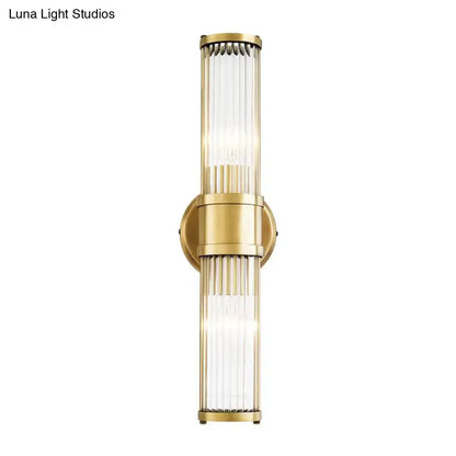 Contemporary gold crystal wall sconce light fixture with vertical ribbed glass panels for living room lighting