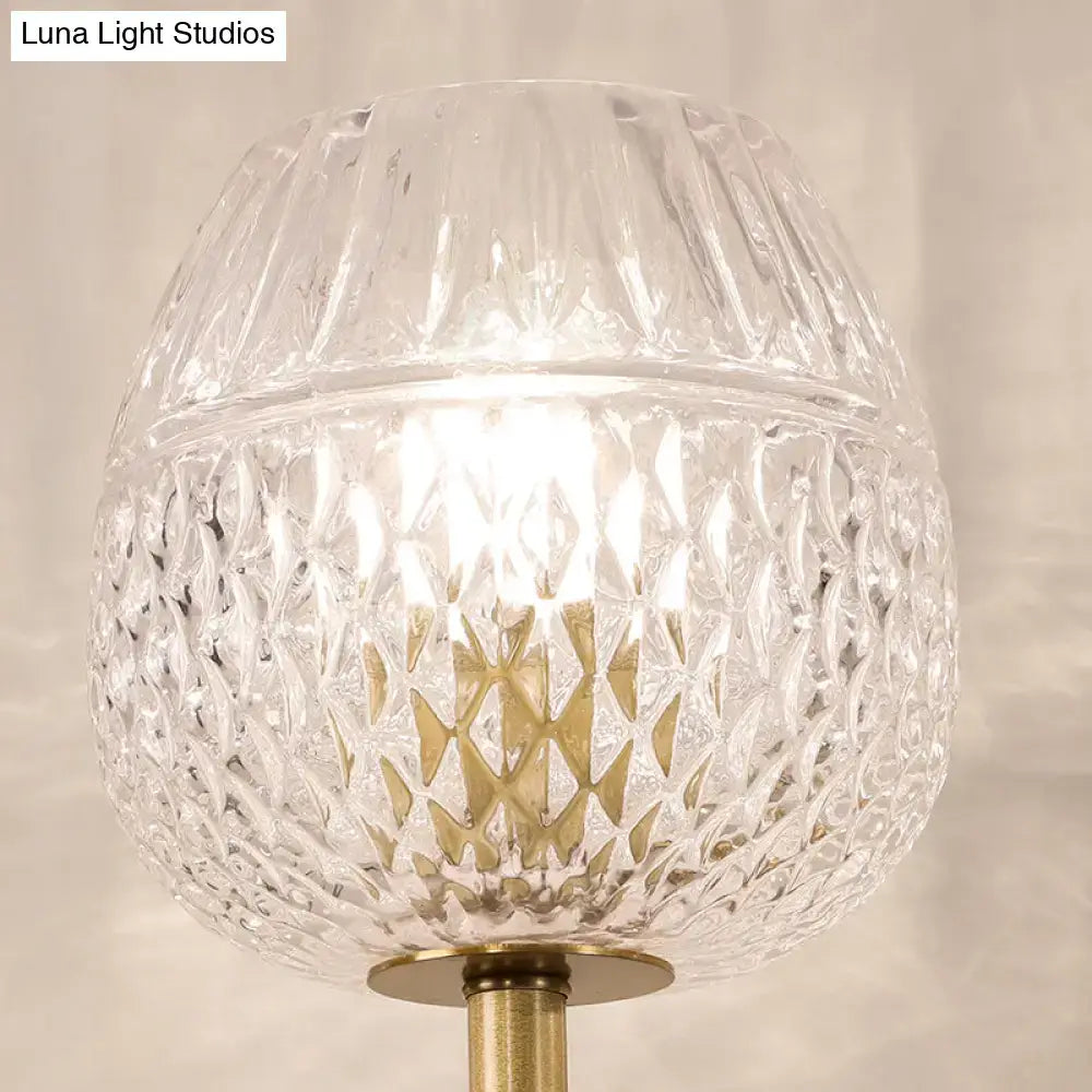 Contemporary gold dome foyer wall light featuring clear lattice glass and a gold-toned metal base
