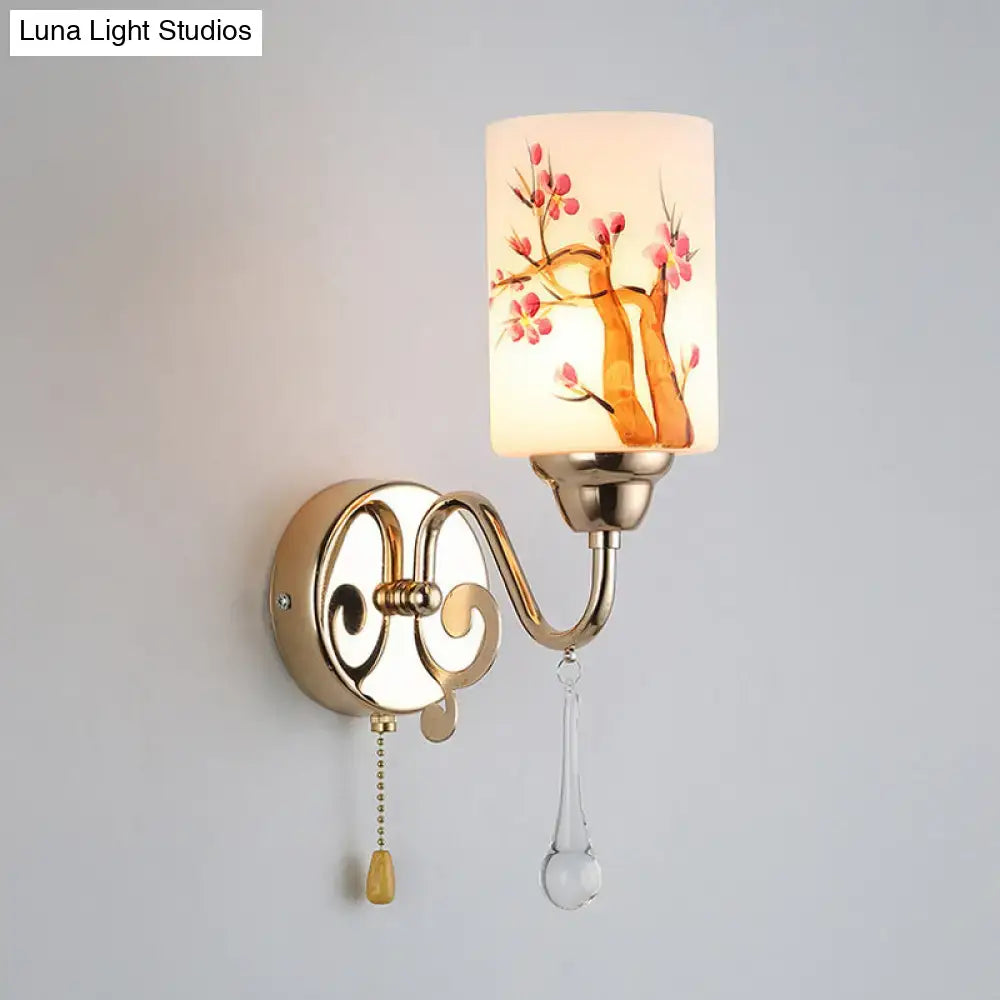 Contemporary wall lamp with gold finish and cream glass shade featuring hand-painted pink cherry blossoms