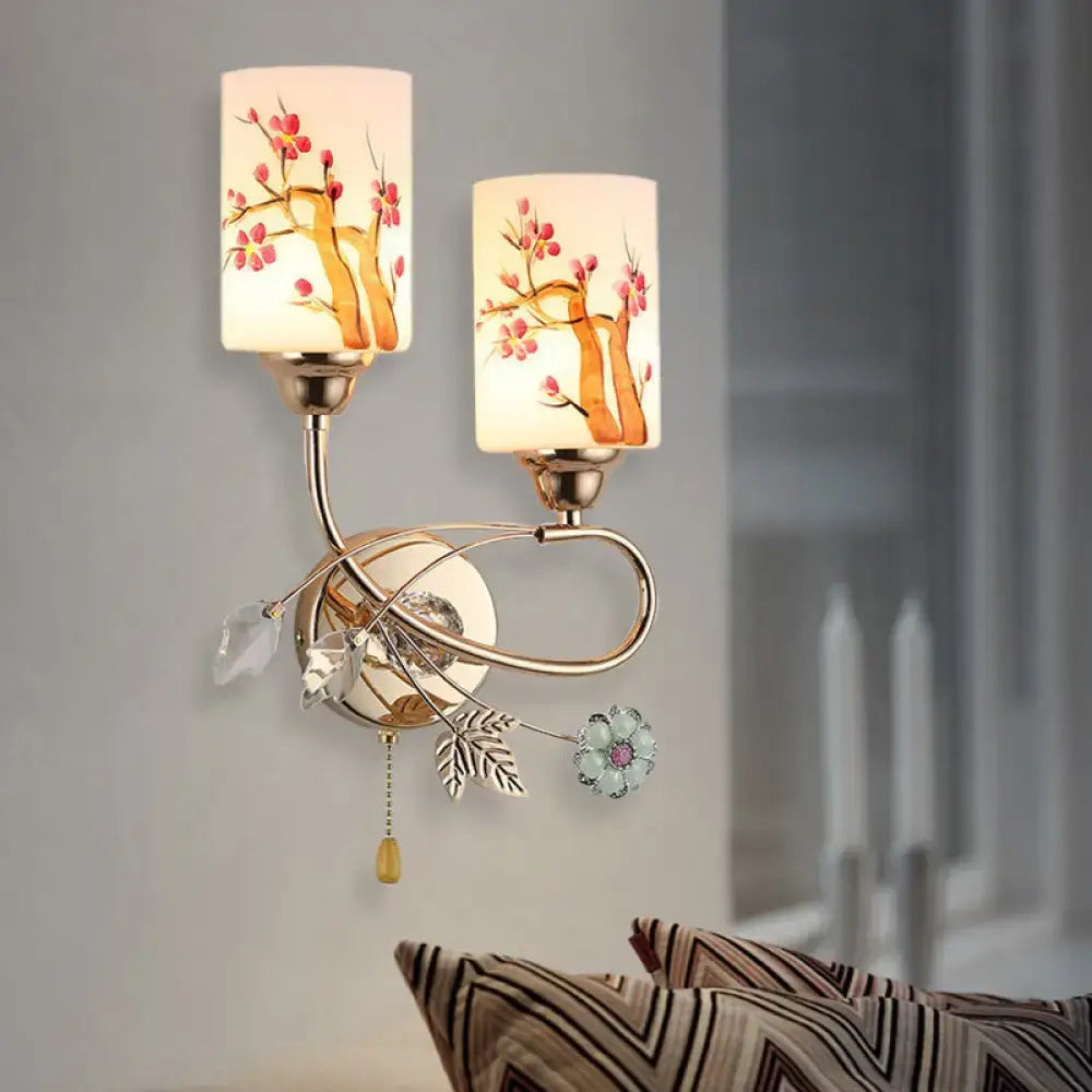 Contemporary gold finish wall lamp with cream glass shades featuring cherry blossom and crystal accents for bedroom use