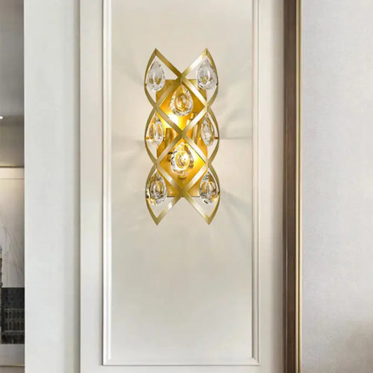 Contemporary gold geometric teardrop sconce light fixture with clear crystal accents for living room decor