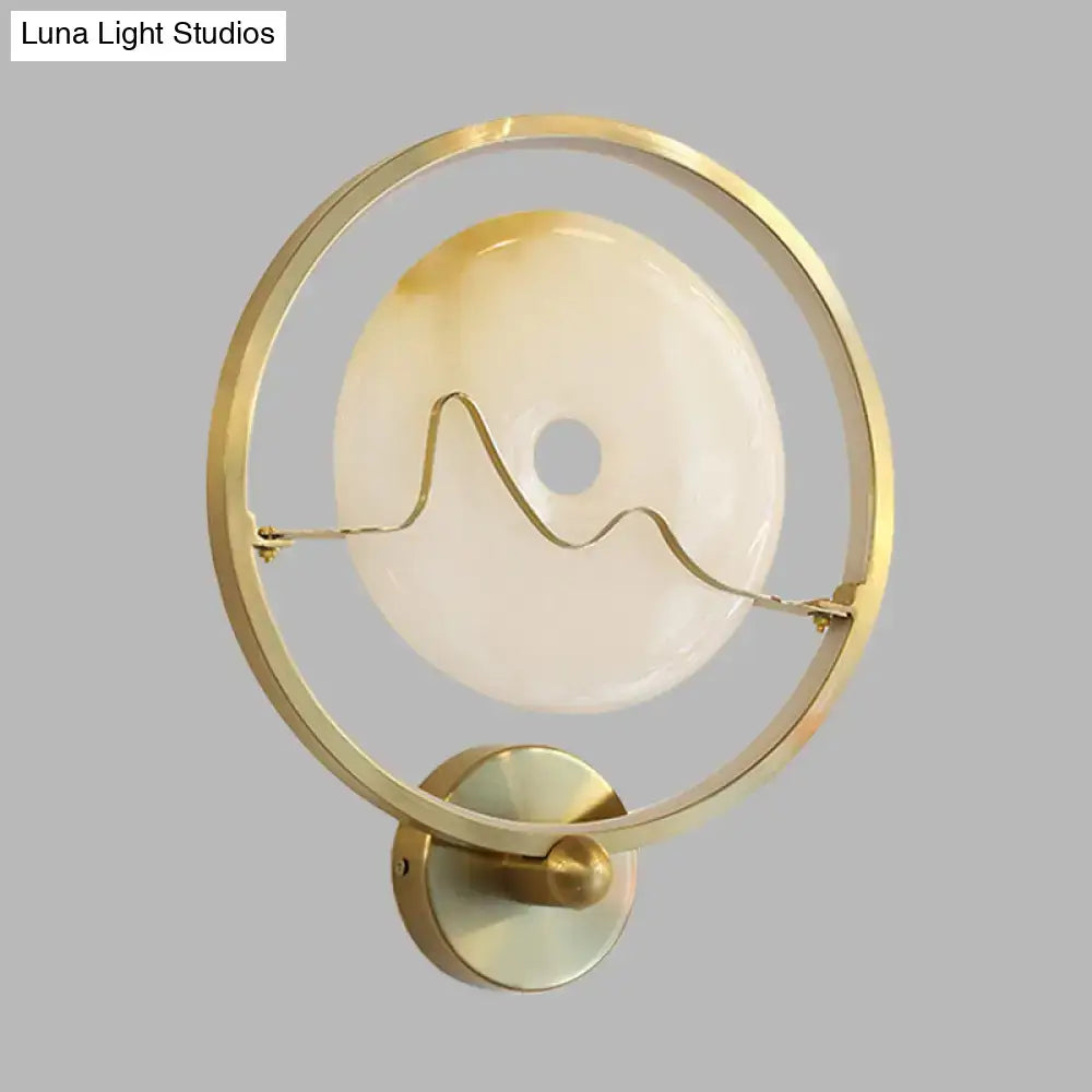 Contemporary wall lamp gold ring with jade and cream opaline glass disc and elegant wavy wire design wall mount