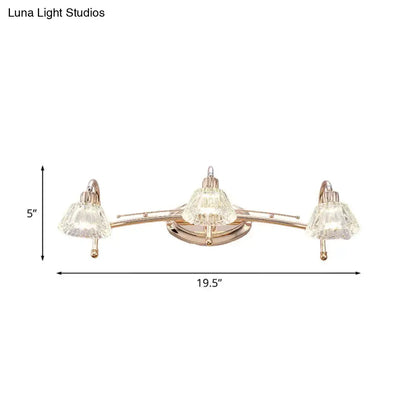 Contemporary rose gold wall vanity light with three clear faceted truncated cone crystal shades for bathroom use