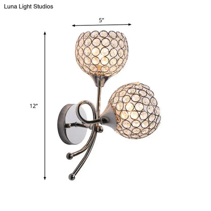 Contemporary silver dual head dome sconce with crystal globe shades featuring circular facet pattern bulb base light type