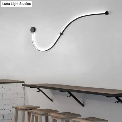 Contemporary twist black curved led wall sconce with sleek minimalist finish and white warm light for bedroom use