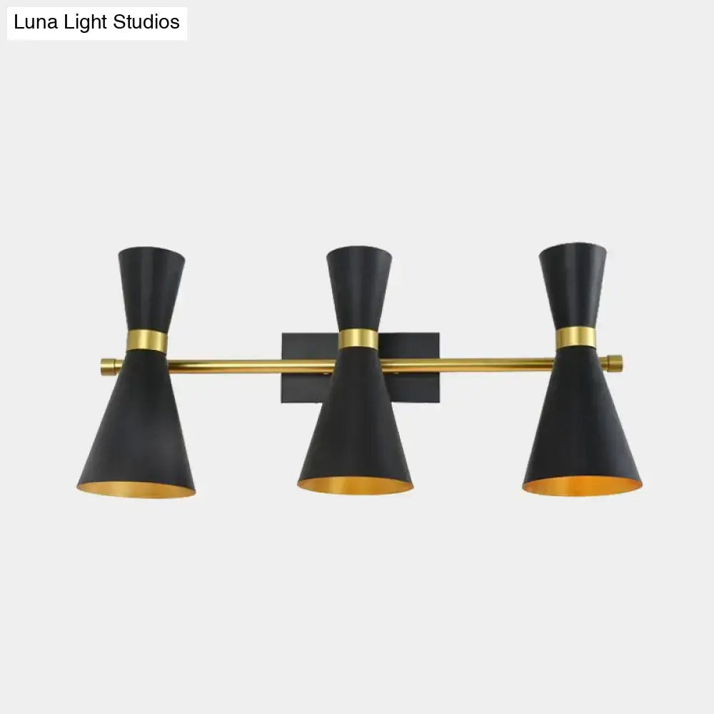 Contemporary black and gold three-light wall sconce with adjustable arm and conical shades for bedroom lighting