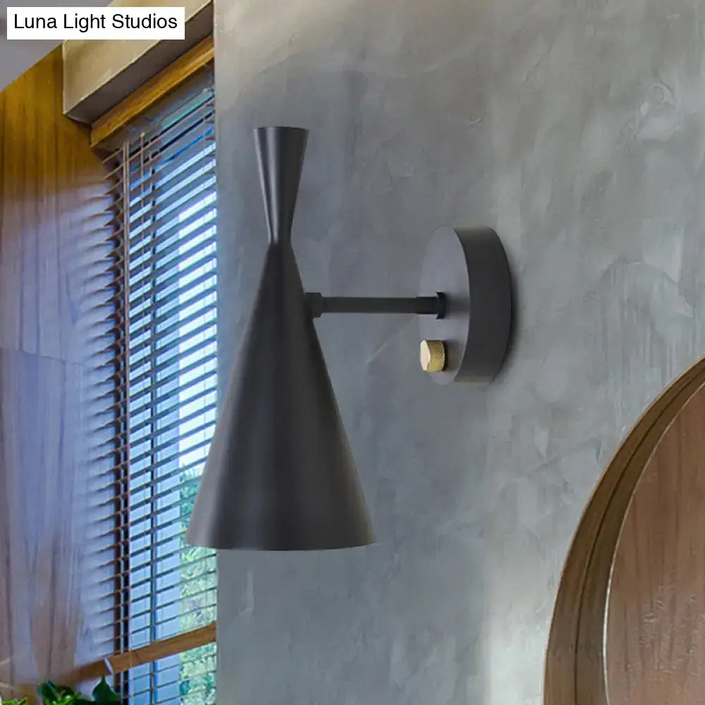 Black matte wall sconce with adjustable arm features sleek conical shade and brass accent ideal for bedroom lighting