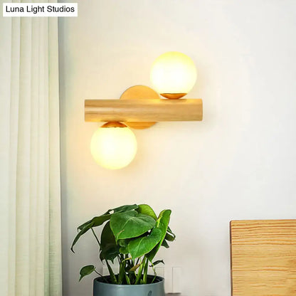 Contemporary white milk glass wall lamp with wooden base featuring two warm spherical bulbs for bathroom lighting