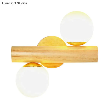 Contemporary white milk glass wall lamp with wooden base featuring natural wood cylinder and gold-toned accents