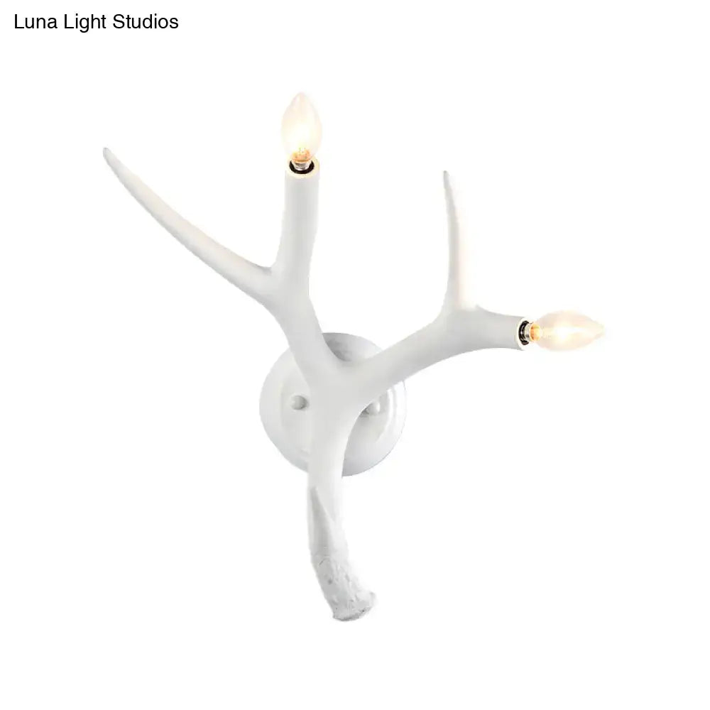 Contemporary white resin antler wall sconce with two illuminated bulbs for restaurant dining room use