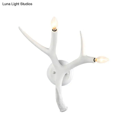 Contemporary white resin antler wall sconce with two illuminated bulbs for restaurant dining room use
