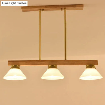 Contemporary wood linear island ceiling light with warm brass finish gold black accents and frosted glass shades