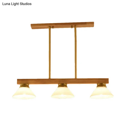 Contemporary wood linear island ceiling light with three frosted glass shades gold black accents for dining room