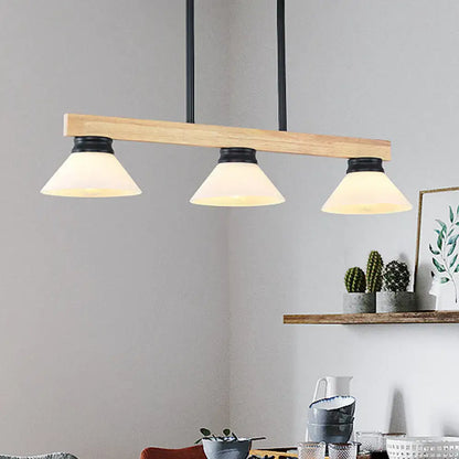 Contemporary wood linear island ceiling light with gold black metal hardware and frosted glass shades in dining room
