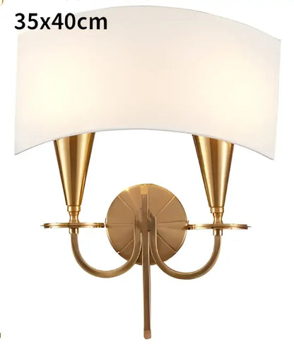 Gold-toned wall sconce with two conical arms and off-white fabric shade for decorbites copper ceiling chandelier collection