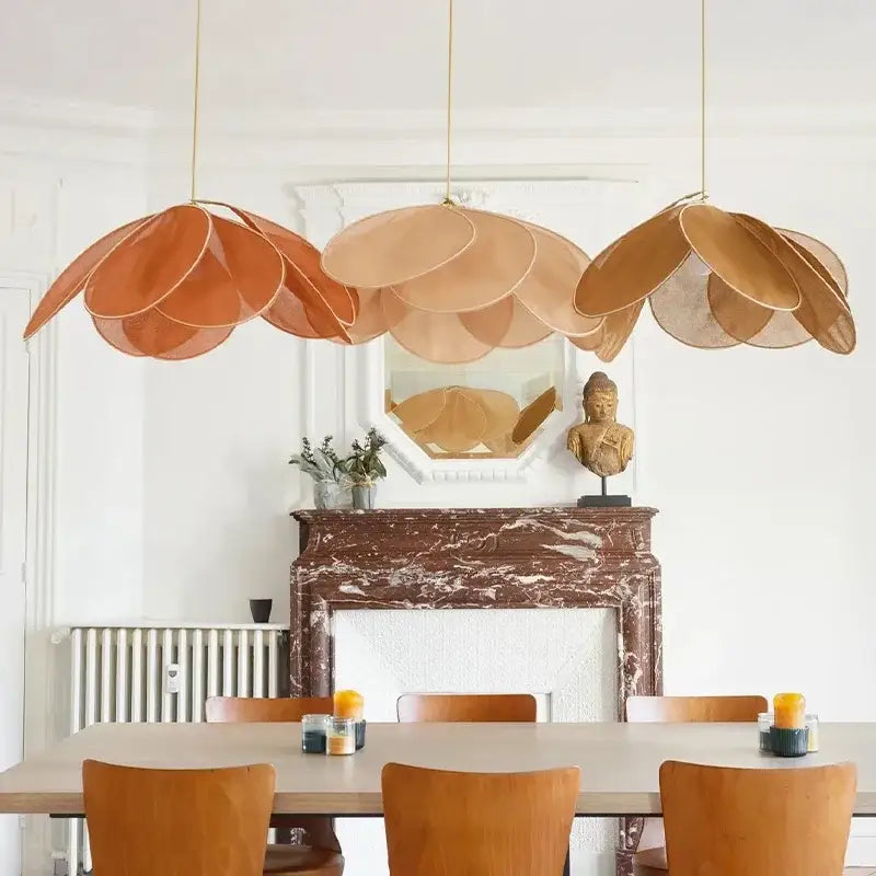 Three hanging pendant lights with layered copper petal fabric shades in warm amber for dining room decorbites colorful petal