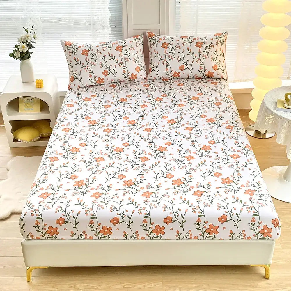 White fitted sheet set with soft orange floral and green leaf flower pattern featuring matching pillowcases