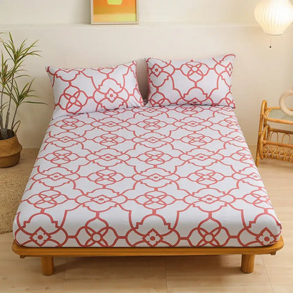 White fitted sheet set with coral red geometric floral pattern featuring interconnected green leaf flower shapes