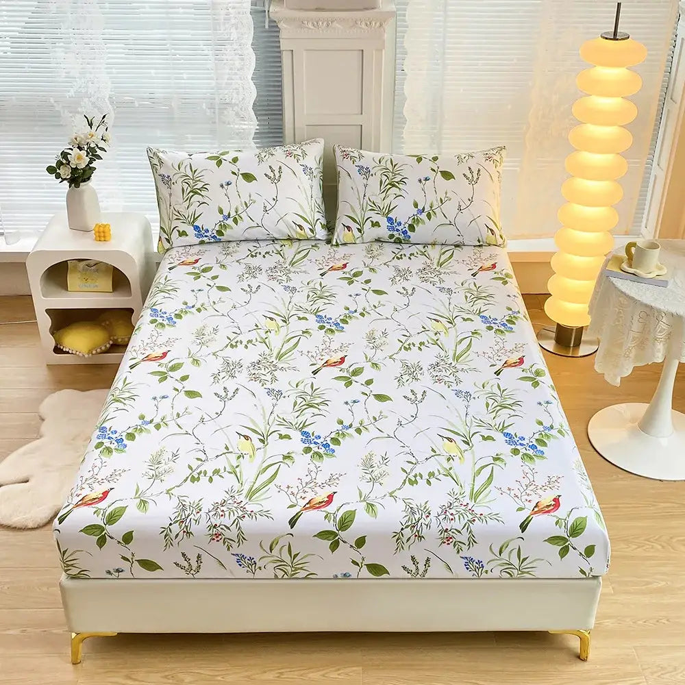 White fitted sheet set with green leaf flower botanical print and small red and yellow birds for bedroom bedding