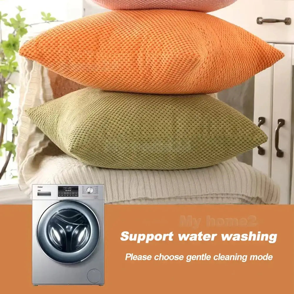 Silver front-loading washing machine with digital display shown next to decorbites corduroy corn kernel throw pillowcase