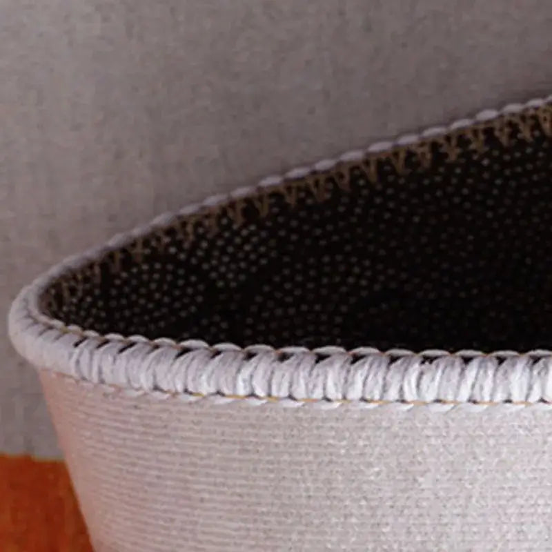 A light gray woven basket with a textured braided rim and dark perforated interior complements decorbites grey crystal velvet entrance rug