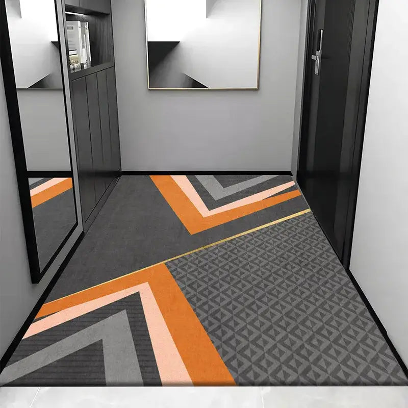 Modern geometric-patterned cosmic grey crystal velvet entrance rug with bold orange gray and black chevron stripes