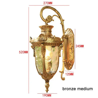 Bronze medium wall lantern with ornate scrollwork and textured glass for outdoor wall use in restaurants