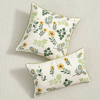 Cream-colored cushion cover with embroidered yellow blue and green floral patterns for living room use