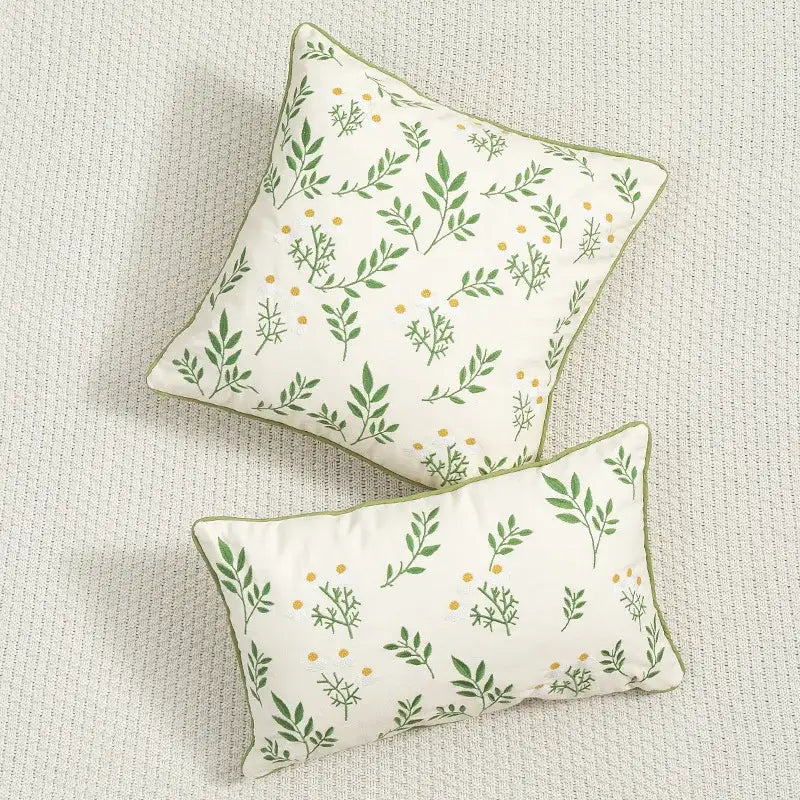 Cream-colored floral embroidered cushion cover with green leaf yellow dot patterns and olive-green trim for living room use