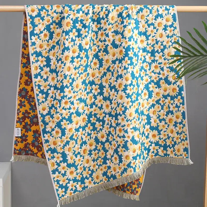 A vibrant blue country flowers cotton knit throw blanket featuring white daisies with fringe decorbites country flowers design