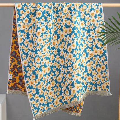 A vibrant blue country flowers cotton knit throw blanket featuring white daisies with fringe decorbites country flowers design