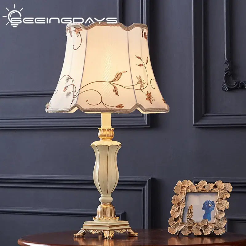 Cream-colored country pastoral desk lamp with gold accents and a floral fabric shade from decorbites country pastoral collection