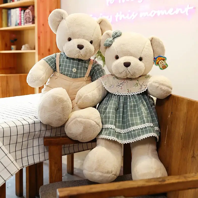 Cream-colored plush toys pair featuring couple bear plush dressed in green plaid outfits with lace trim and suspenders