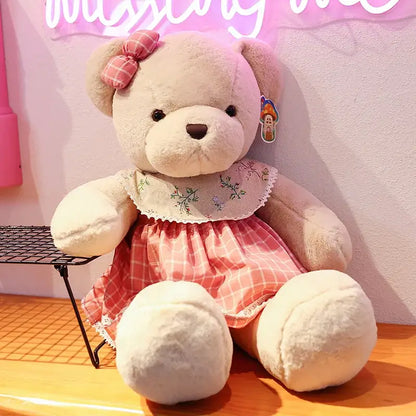 A plush toys couple bear with soft beige fur wearing a pink and white plaid dress and matching head bow by decorbites