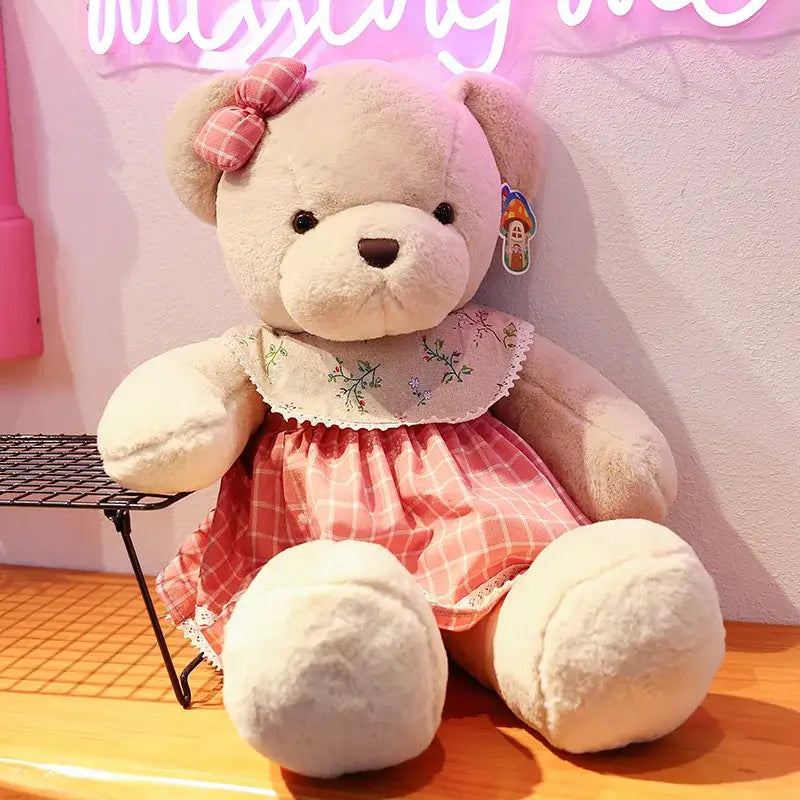 A plush toys couple bear with soft beige fur wearing a pink and white plaid dress and matching head bow by decorbites