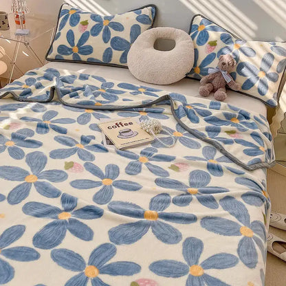 Blue floral patterned fleece blanket with cream background and gray trim from decorbites cozy checkered fleece collection