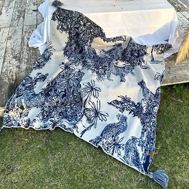 Blue and white patterned throw blanket with chinese ink knit toile design featuring animals and tassels for decorbites cozy chinese decor