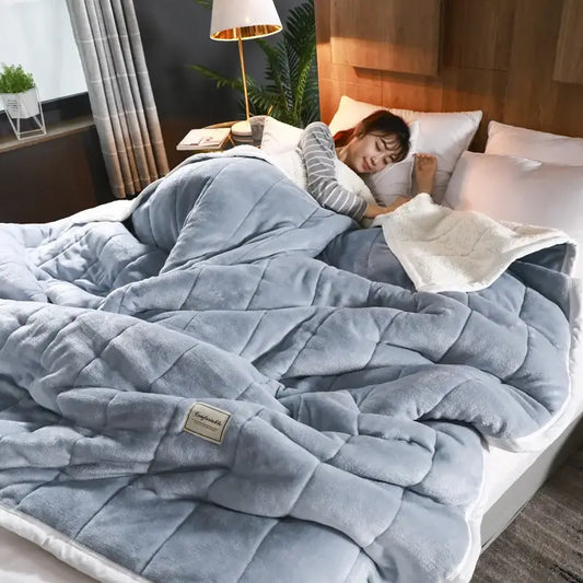 Soft blue quilted cozy coral fleece blanket with plush texture and white inner lining for bedroom decorbites cozy coral