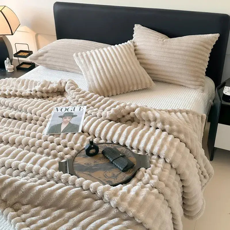 Cream-colored plush throw blanket with textured wavy ribbed pattern made of coral fleece for decorbites cozy coral fleece use