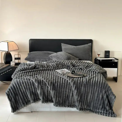 Plush gray corduroy throw blanket with soft textured surface and ribbed vertical stripes for cozy coral fleece decorbites