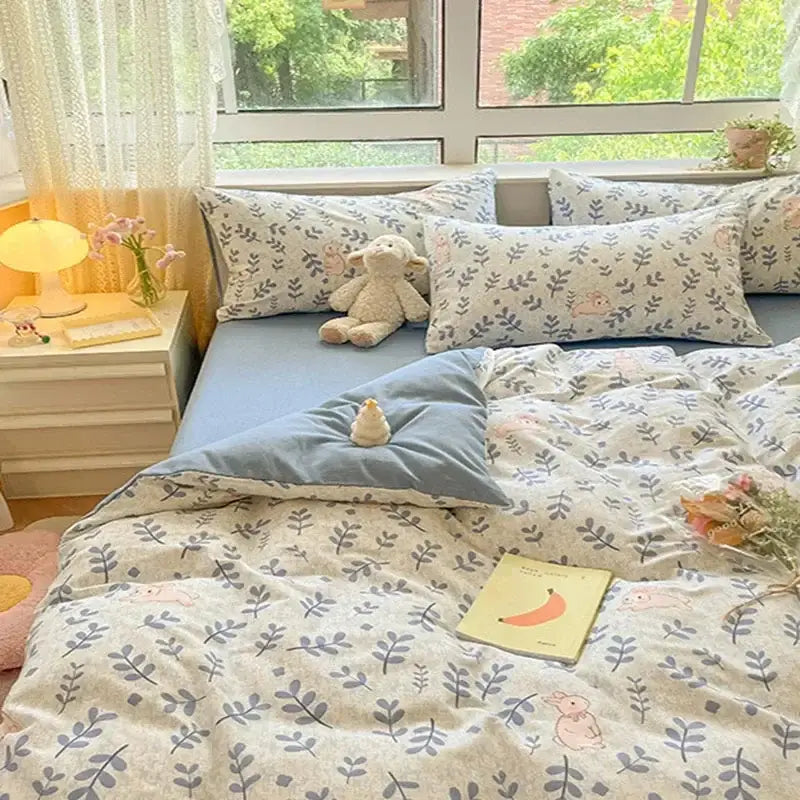 Pastel blue and cream cozy cotton bedding set with delicate leaf and pink bunny pattern by decorbites cozy cotton