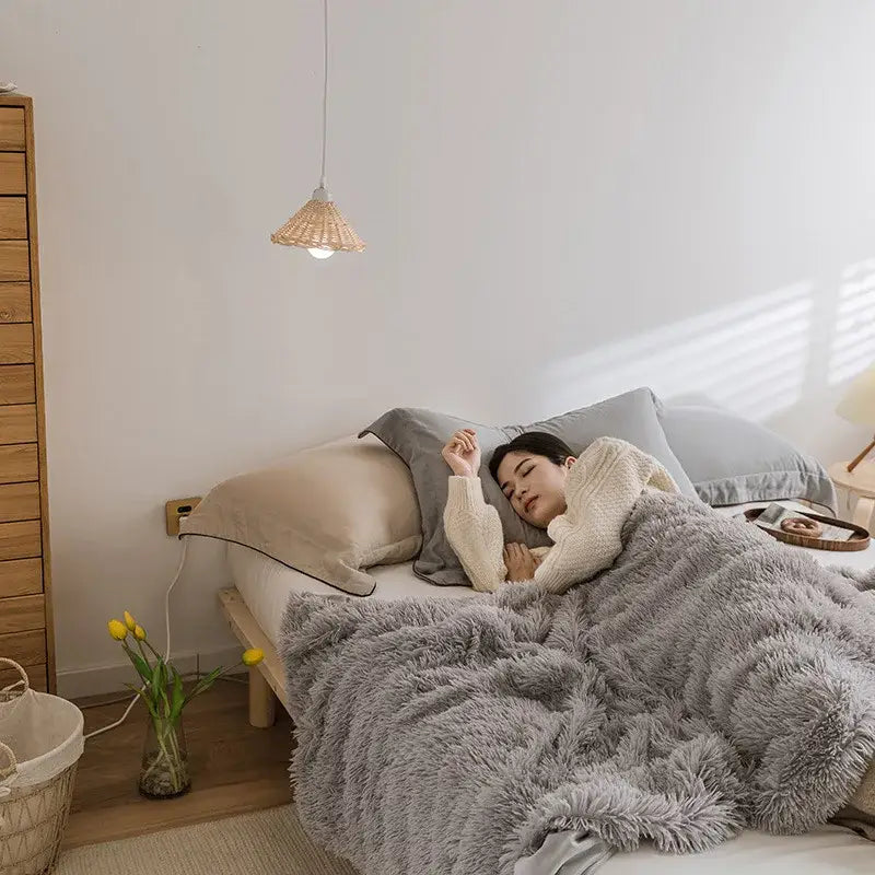 A cozy faux fur throw blanket in gray with a soft fluffy texture perfect for bedroom decorbites cozy faux style